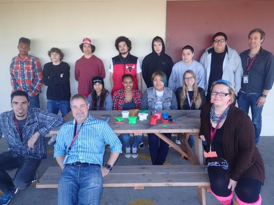 Students and educators pose with 3D printed objects.