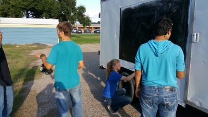 Students of the science club get busy painting the mobile observatory’s exterior in the new color scheme.