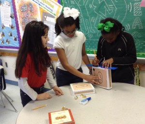 Students creating cigar box guitars. Project caption: 