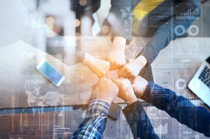 Photo of fists in circle as in representing coming together